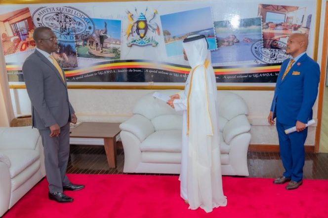 Hon-John-Mulimba-receives-copies-of-credentials-from-Amb-designate-Al-Zaidi-looking-on-in-blue-suit-is-Amb.-Yahya-Semuddu-Special-Envoy-to-Qatar-and-Chief-of-Protocol-Amb.-Charles-Ssentongo-